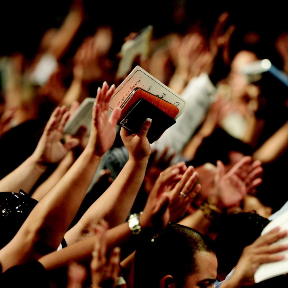 People with hands up in worship